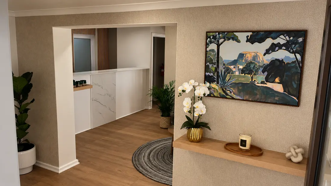 Reception entrance with textured wallpaper, floating oak shelf, orchid and landscape artwork