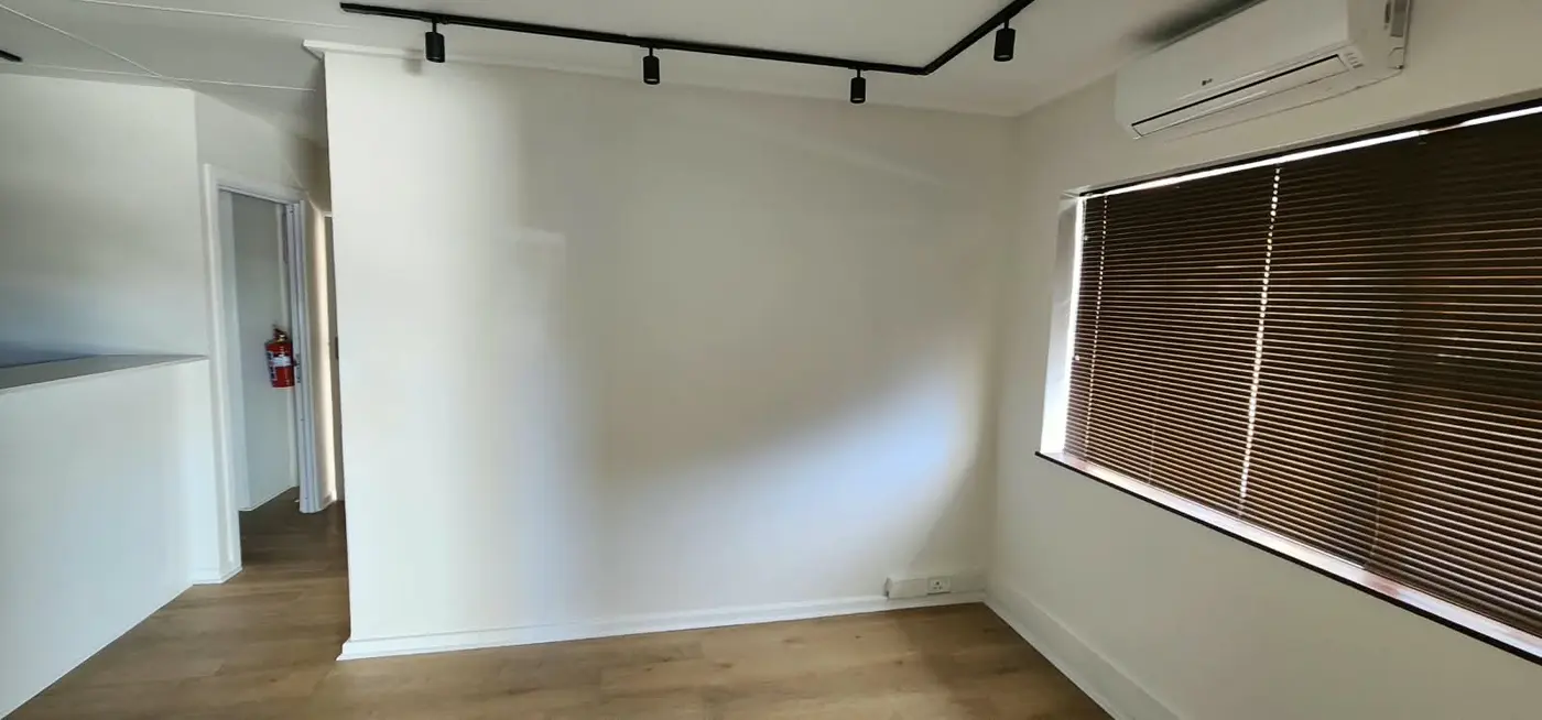 Before: empty white waiting room at Dr Sekwati's practice in Mossel Bay